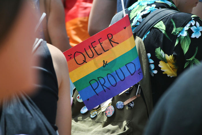 Pride flag with "Queer & Proud" at a science museum event amid backlash over alleged anti-LGBT claims.