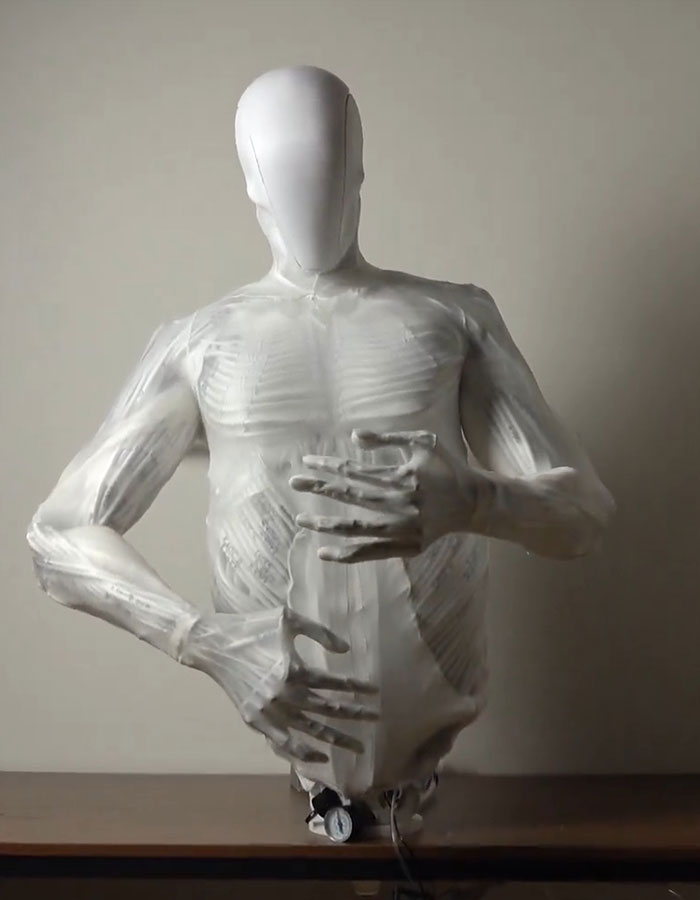 Humanoid robot with lifelike muscles displayed in a neutral setting.