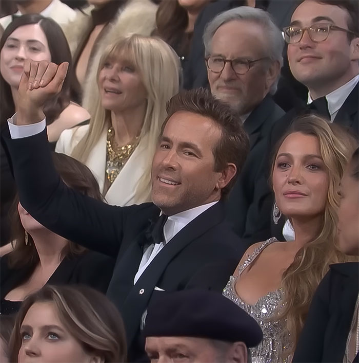 Blake Lively and Ryan Reynolds seated in formal attire at a public event.