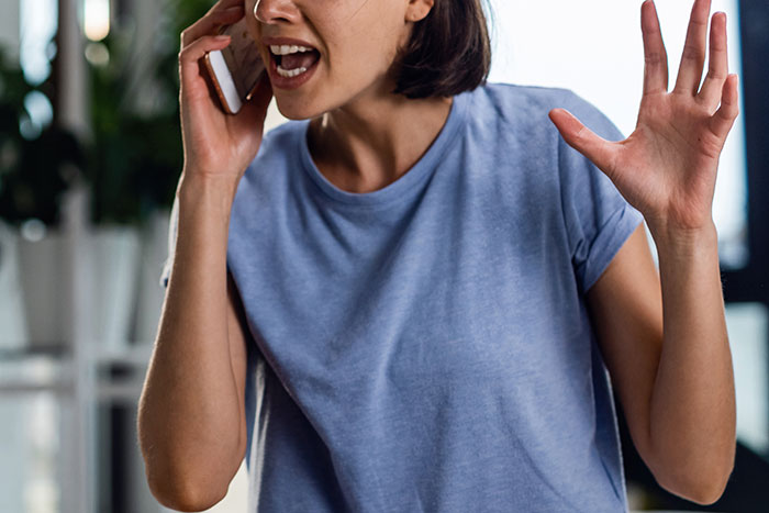 Woman on phone, upset, discussing a friend breaking into her house while she's away.