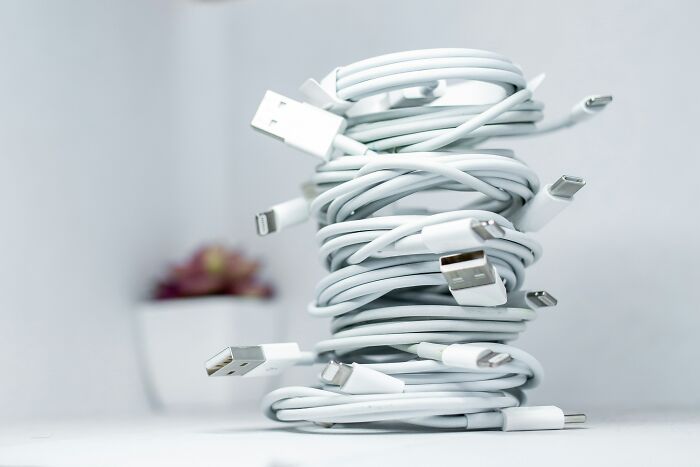 Various coiled charging cables stacked, a travel must-have for organized packing.