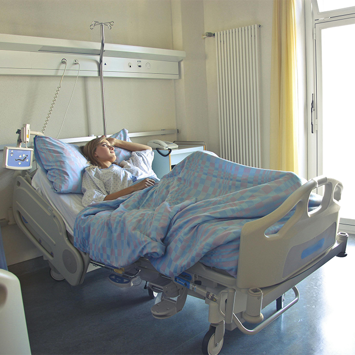 A patient in a hospital bed, linked to discussion on Covid vaccines and new syndrome.