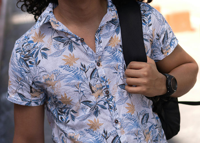 Person wearing a floral shirt, carrying a backpack; focus on the strangest punishment concept.