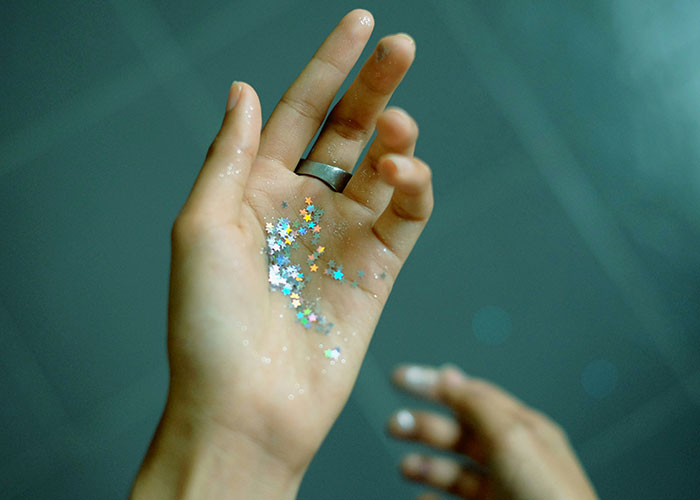 A hand holding glittery stars, symbolizing a strange punishment story.