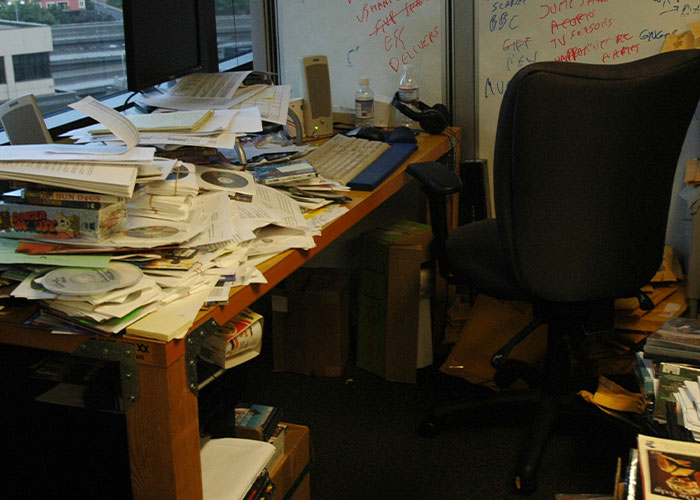 Messy office desk covered in papers and clutter, possibly resembling a strange punishment.