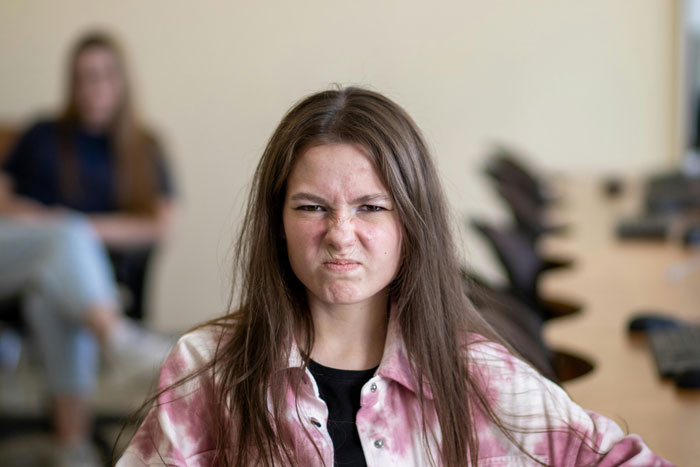 Teen showing frustration in a shared living space.