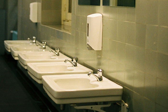 Dirty sinks in a bathroom indicating a bad restaurant environment.