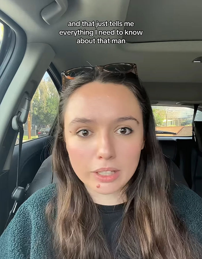 Woman talking in a car, expressing disappointment over booing Taylor Swift at the Super Bowl.