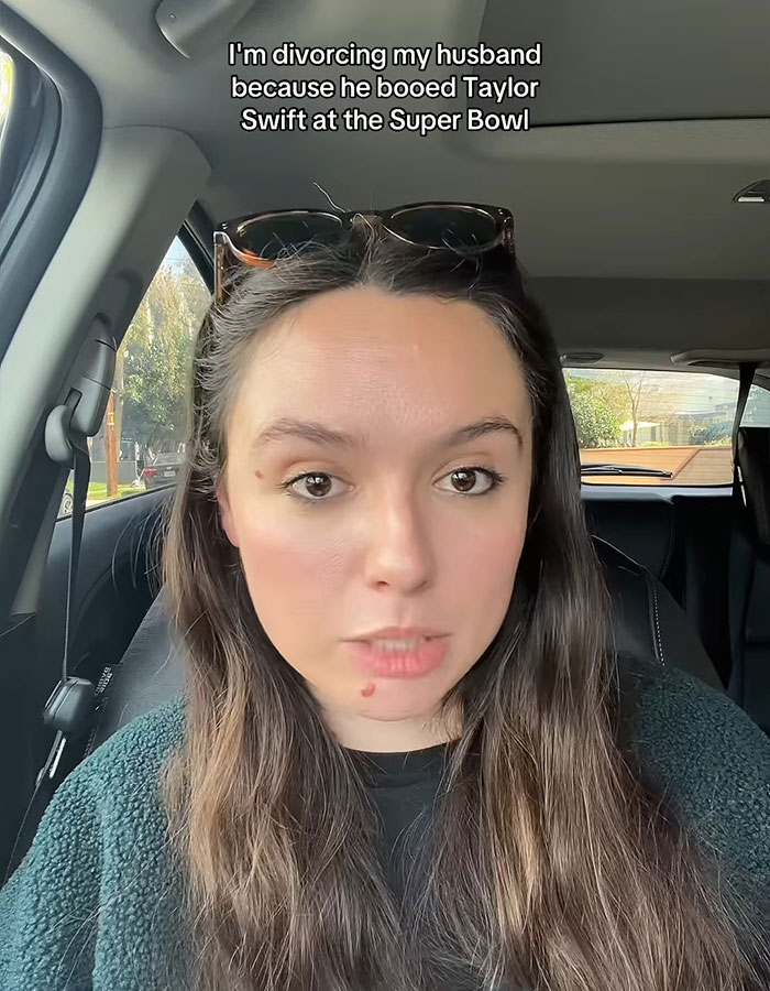 Woman in car discussing divorce over husband booing Taylor Swift at Super Bowl.