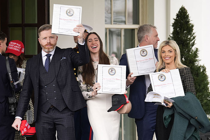 Group holding documents outside the White House related to secret Epstein files with celebrity names.