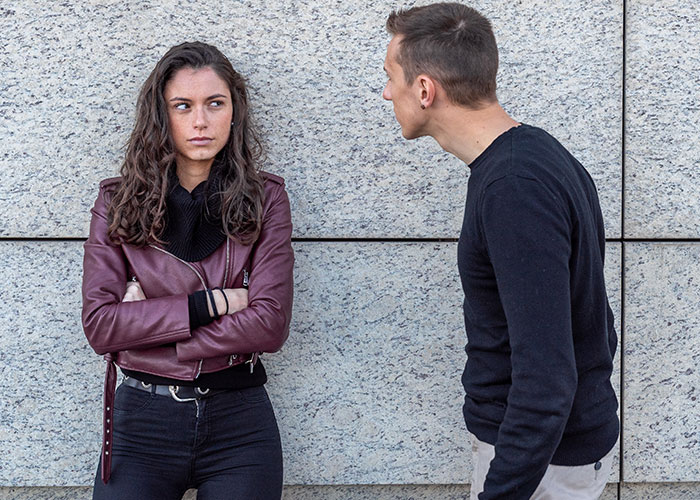 Man and woman having a serious conversation, illustrating relationship misunderstandings.