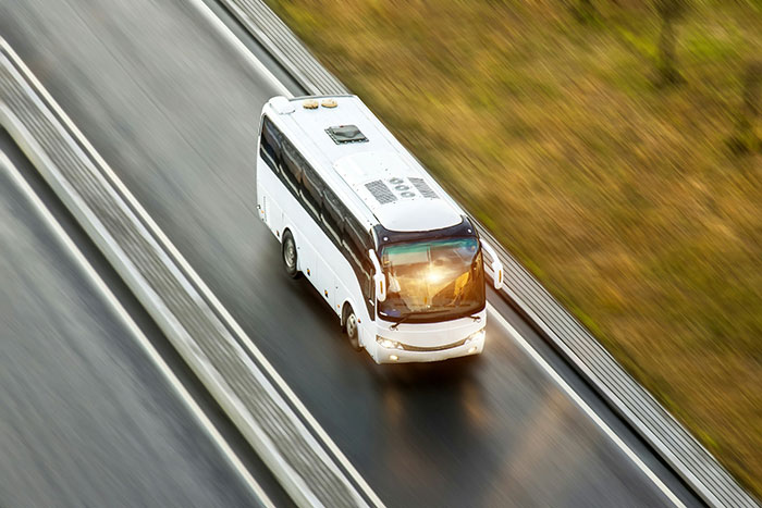 Frugality bus journey on a highway, showcasing cost-effective travel habits.