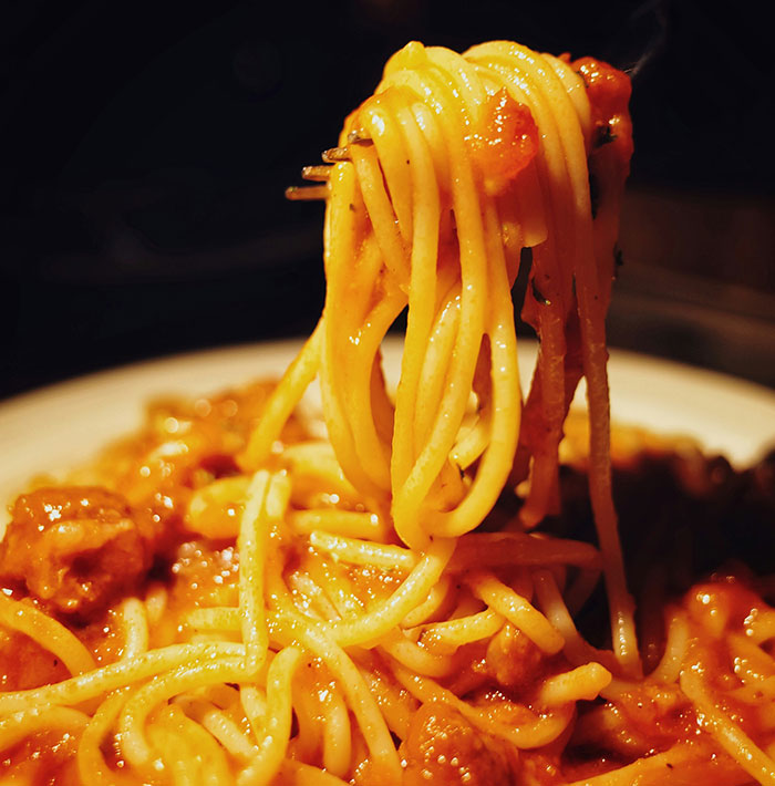 Spaghetti being lifted with a fork, illustrating a frugality story involving leftover pasta.