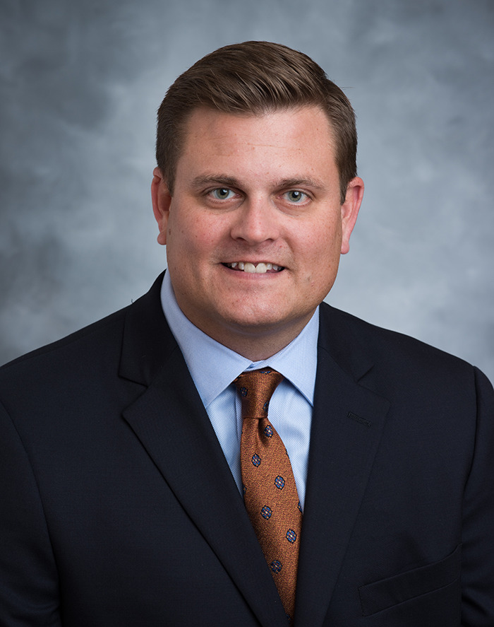 A man in formal attire and tie posing, related to UnitedHealthcare legal issue.