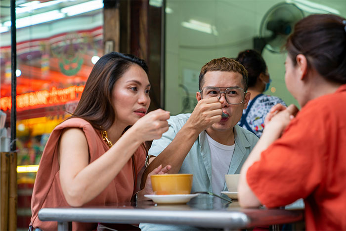 Friends dining together at a restaurant, enjoying their meal.