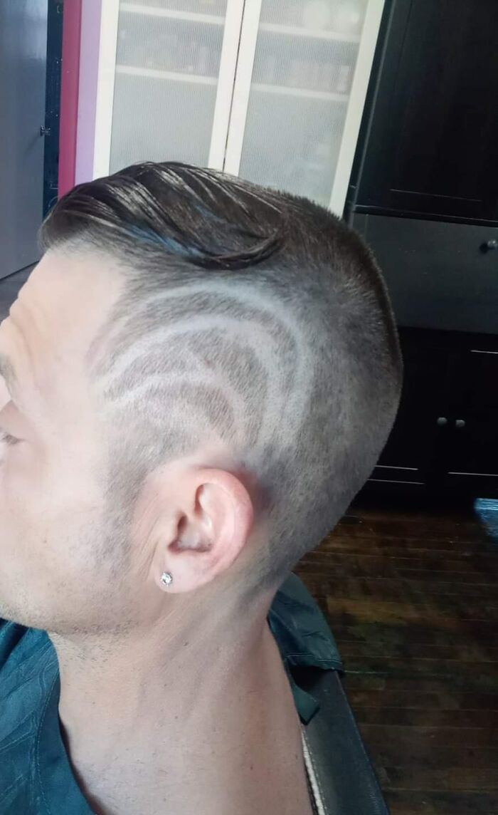 Man with unusual haircut featuring patterned shaved design; example of hair fails.