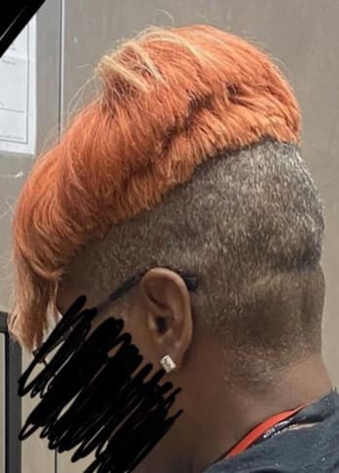 A person with an uneven orange and shaved hairstyle, representing a hair fail.