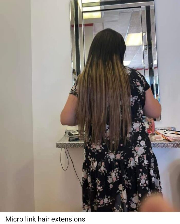 Woman with mismatched hair extensions facing a mirror, showcasing a hairstyle fail.