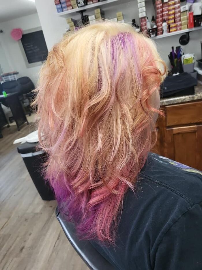 Colorful hair fail with uneven purple and blonde shades in a salon setting.