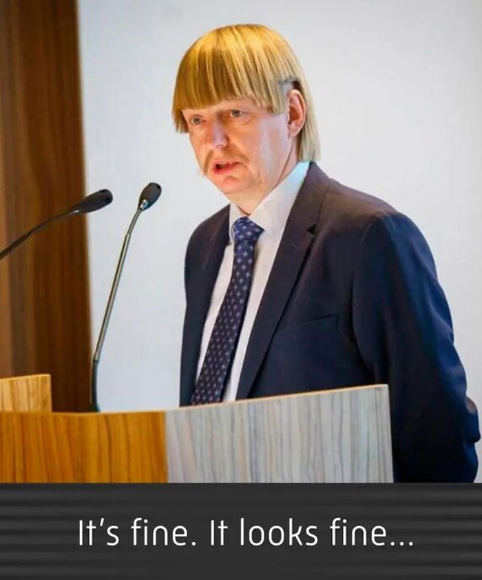 Man with a comically bad haircut speaking at a podium, illustrating a hair fail.