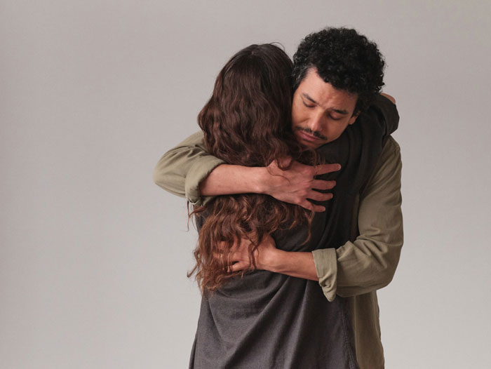 Man hugging a woman with eyes closed, feeling empty and emotional after canceling a wedding.