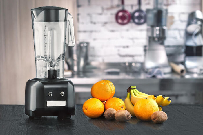 Cheap blender with assorted fruit on a kitchen counter, highlighting budget-friendly alternatives.