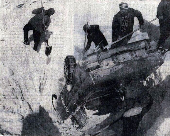 Workers excavating a partially buried car in snowy conditions, highlighting one of many cool Wikipedia articles.