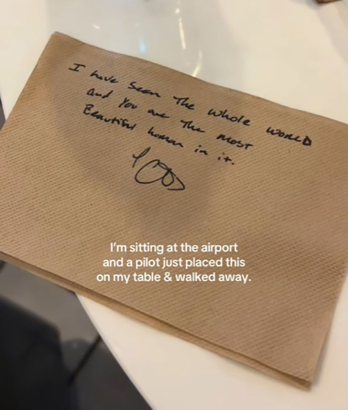 Napkin with a handwritten romantic note from pilot to passenger at airport.