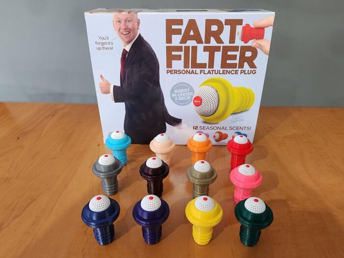 Colorful fart filter plugs on display, packaging includes humorous text related to toilet humour.