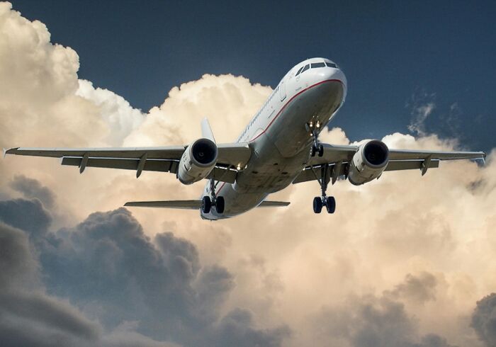 Airplane flying through cloudy sky, capturing the essence of cool Wikipedia articles.