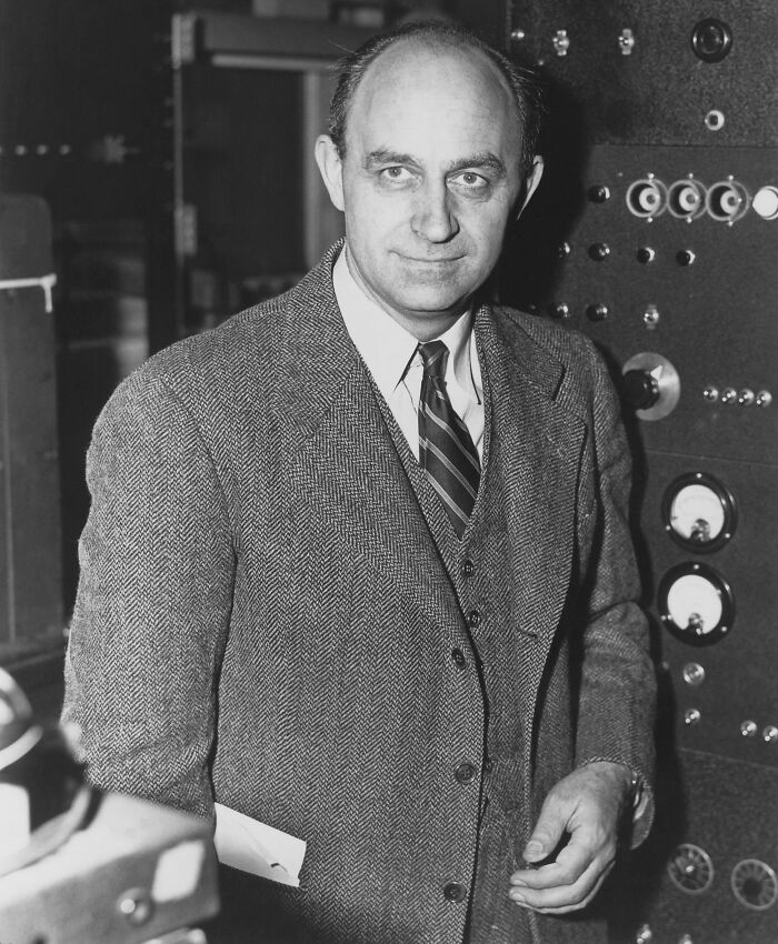 Man in a tweed suit standing near a control panel, related to cool Wikipedia articles.