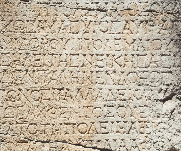 Ancient stone with Greek inscriptions, highlighting cool Wikipedia articles for reading and exploration.