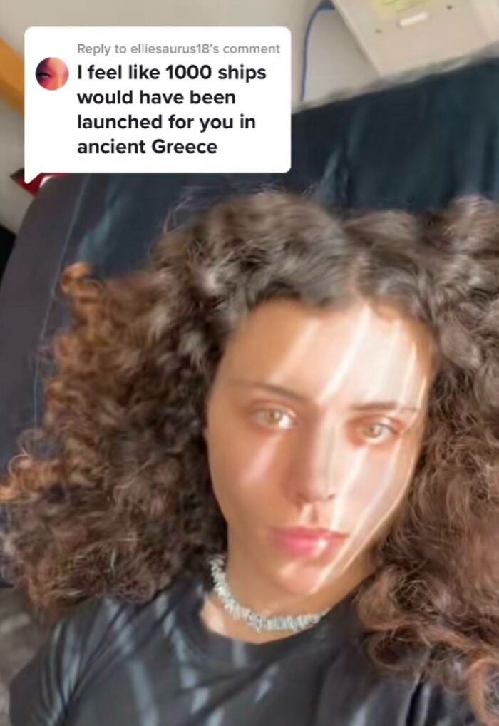 Person with curly hair reads a rare compliment about ancient Greece.