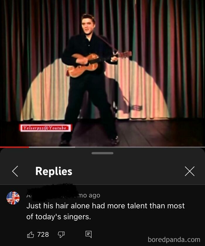 Performer on stage with a guitar, receiving a humorous rare compliment comparing his hair to modern singers' talent.