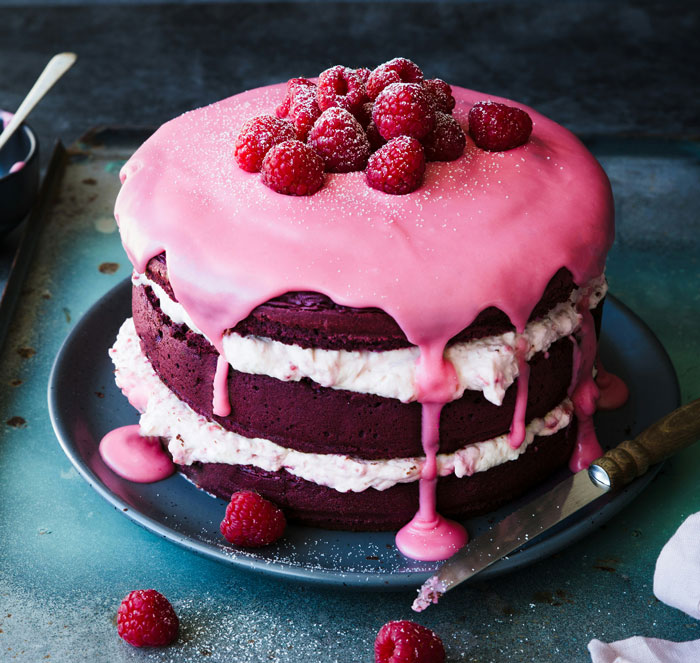 Birthday cake with pink icing and raspberries, celebrating a special 25th birthday occasion.