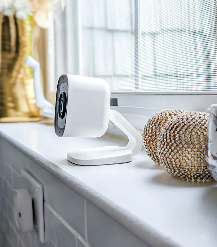 Camera placed on a windowsill, part of a security setup.