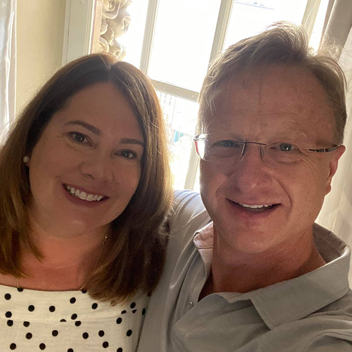 A smiling couple near a window in a photo related to a casino lawsuit.