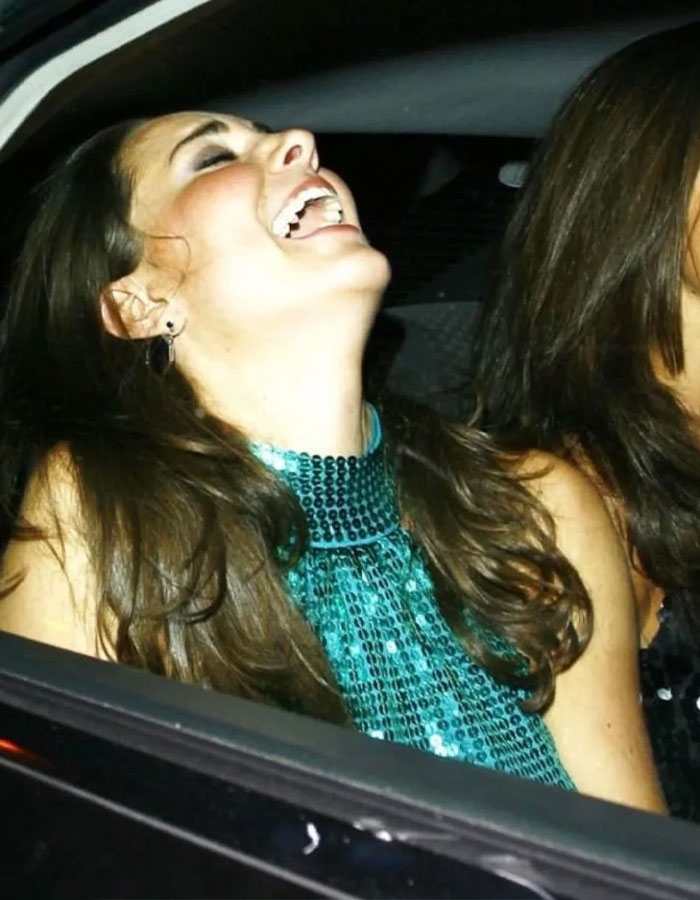 ```plaintext Woman joyfully laughing in a car, wearing a turquoise sequin dress, showing a stunning smile. ```