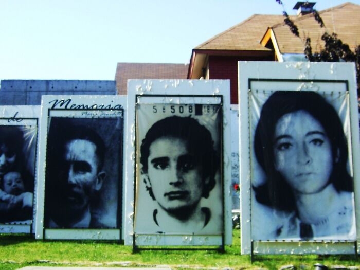 Large portraits displayed outdoors, showcasing historical black and white images.