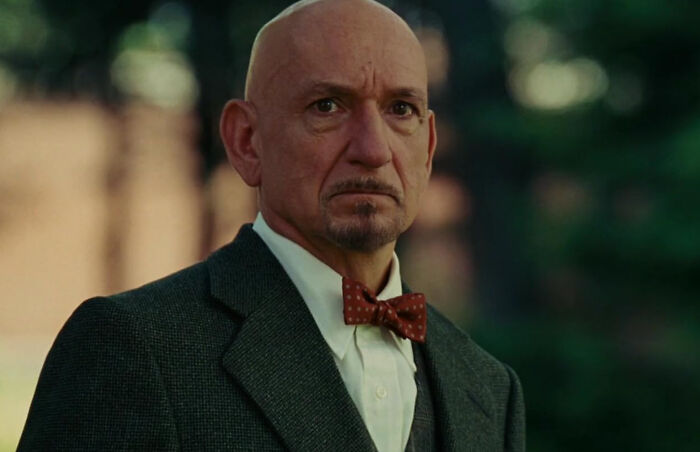 A man in a suit and bow tie stands outdoors, providing a fresh perspective on style.