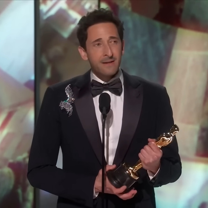 Adrien Brody holding Oscar, delivering a speech at the ceremony.