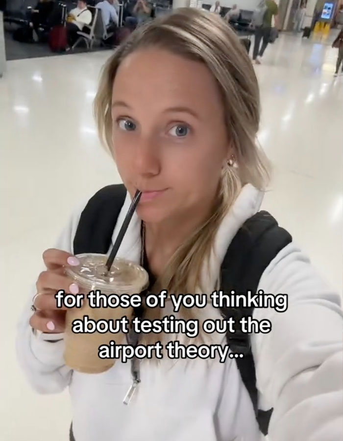 Person sipping iced coffee with text overlay about airport theory in a busy terminal.