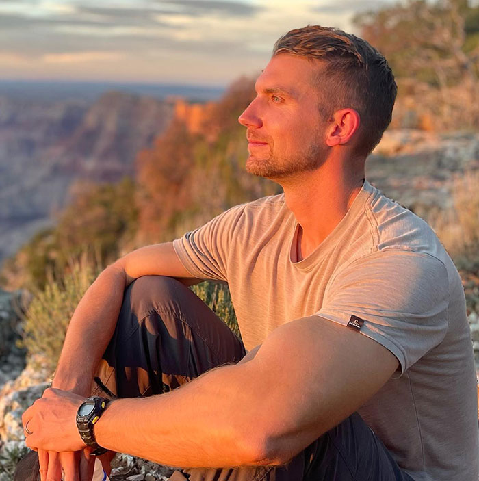 Man sitting outdoors at sunset, associated with YouTube star tragedy news.