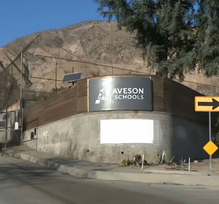 Aveson Schools sign by a road, related to Steve Carell's praised help for LA fire victims.