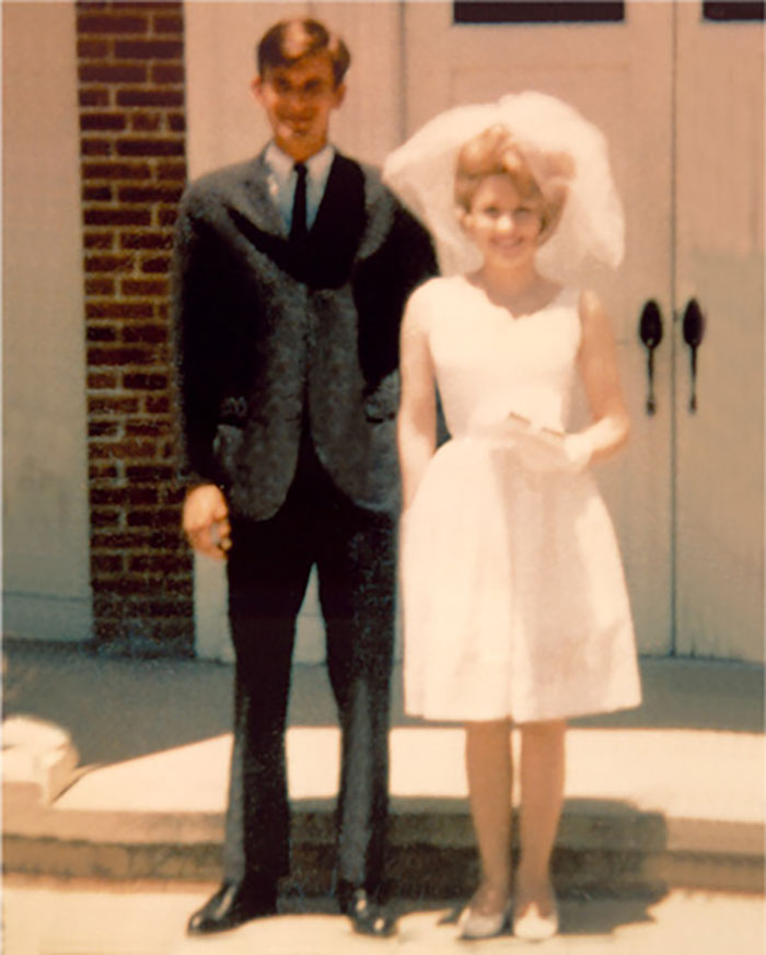 Couple stands together in wedding attire, symbolizing a laundromat love story.