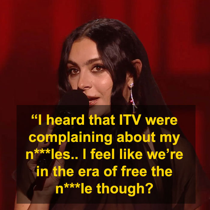 Person discussing complaints about a show, mentioning free expression issues with a microphone on stage.