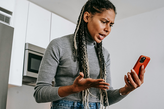 Woman arguing on phone, upset about kid&rsquo;s college fund issue.