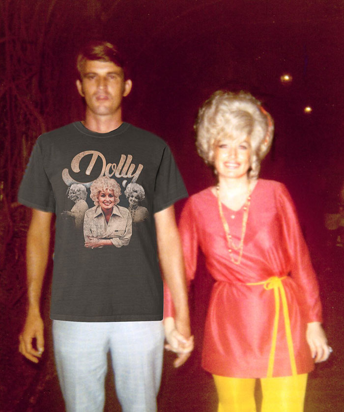 A man in a Dolly Parton t-shirt holds hands with a woman in a red dress.