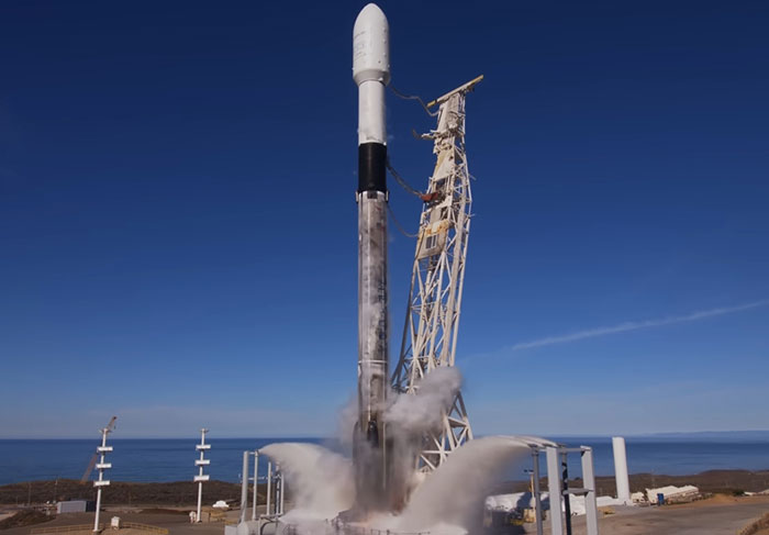 SpaceX rocket on launch pad with clear skies, linked to delayed astronaut rescue mission.