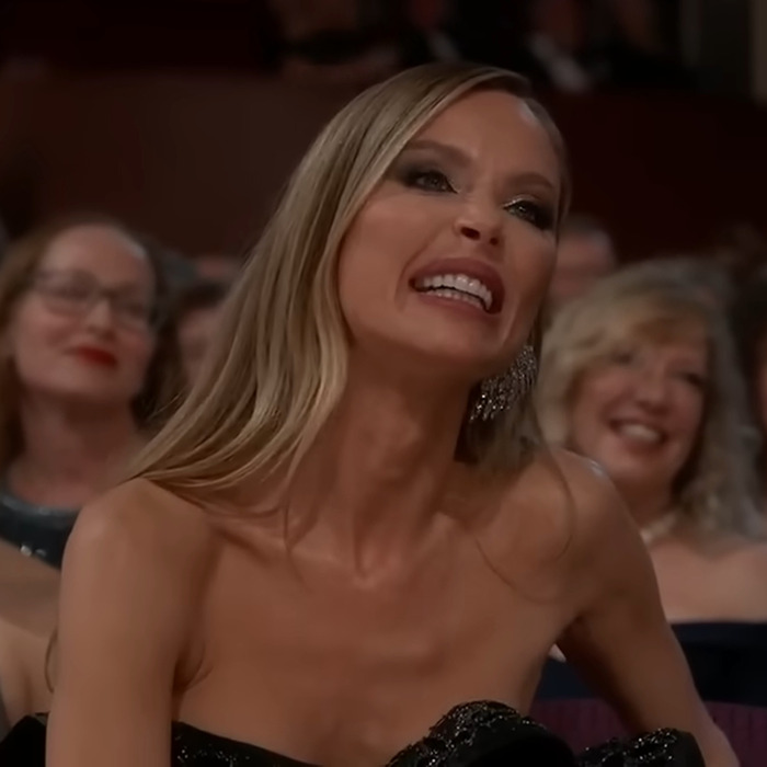 Smiling woman in audience at Oscars, associated with Harvey Weinstein and Adrien Brody's message.